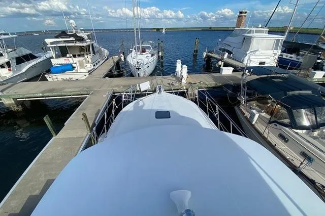 Thistle Do Nicely Yacht Photos Pics 1997 Navigator 4200 yacht docked at marina with other boats under a clear sky.