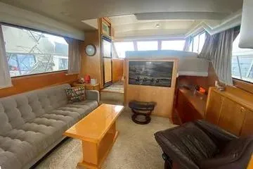 Thistle Do Nicely Yacht Photos Pics Interior of 1997 Navigator 4200 yacht with cozy seating and wooden furnishings.