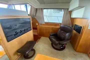 Thistle Do Nicely Yacht Photos Pics Interior of 1997 Navigator 4200 yacht with leather chair and large window.