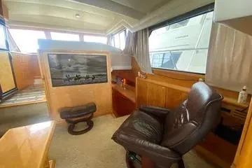 Thistle Do Nicely Yacht Photos Pics Interior of 1997 Navigator 4200 yacht with leather chair and wooden furnishings.