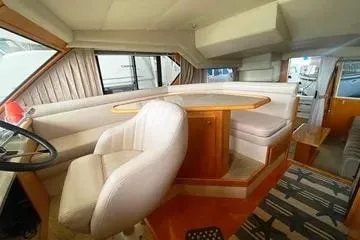 Thistle Do Nicely Yacht Photos Pics Interior of a 1997 Navigator 4200 yacht with plush seating and wooden accents.