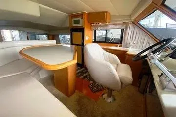 Thistle Do Nicely Yacht Photos Pics Interior of a 1997 Navigator 4200 yacht with seating and helm station.