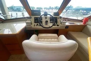 Thistle Do Nicely Yacht Photos Pics Captain's chair and helm of 1997 Navigator 4200 yacht, featuring steering wheel and controls.