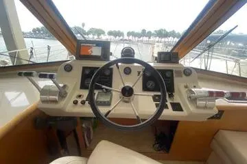 Thistle Do Nicely Yacht Photos Pics 1997 Navigator 4200 yacht helm with steering wheel, controls, and navigation equipment.
