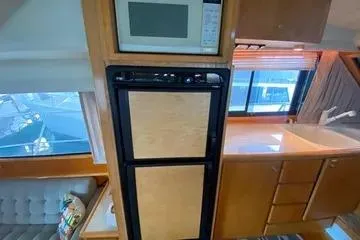 Thistle Do Nicely Yacht Photos Pics Interior of 1997 Navigator 4200 yacht kitchen with microwave and fridge.