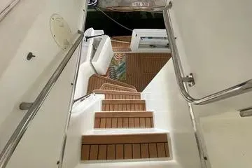 Thistle Do Nicely Yacht Photos Pics Staircase on 1997 Navigator 4200 yacht with wooden steps and white railings.