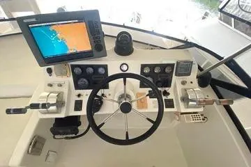 Thistle Do Nicely Yacht Photos Pics Cockpit of 1997 Navigator 4200 yacht with navigation equipment and steering wheel.