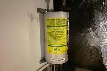 Thistle Do Nicely Yacht Photos Pics Fuel filter system in a 1997 Navigator 4200 boat, mounted on a wall.