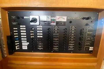Thistle Do Nicely Yacht Photos Pics Electrical control panel of a 1997 Navigator 4200 boat with switches and gauges.