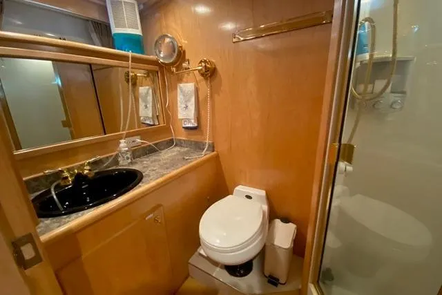 Thistle Do Nicely Yacht Photos Pics Luxurious bathroom in 1997 Navigator 4200 yacht with wood accents and modern fixtures.