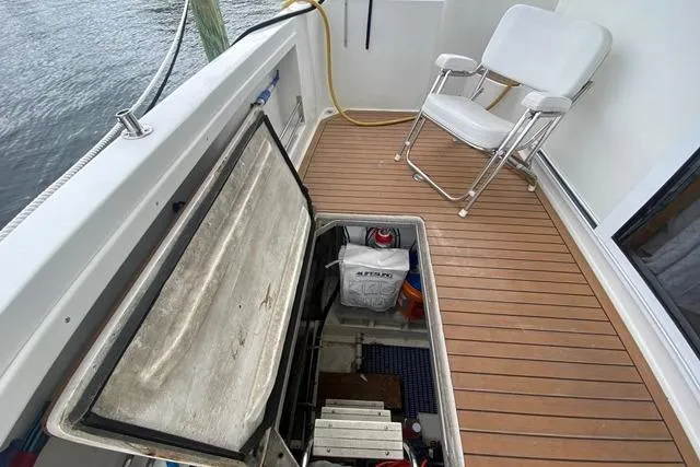 Thistle Do Nicely Yacht Photos Pics 1997 Navigator 4200 yacht deck with storage hatch and folding chair.