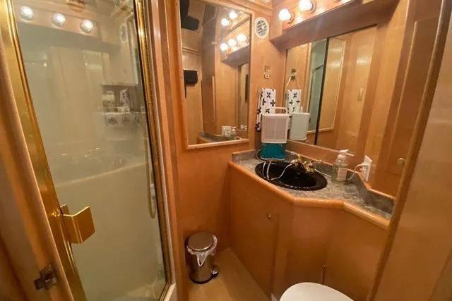 Thistle Do Nicely Yacht Photos Pics Luxurious bathroom in 1997 Navigator 4200 yacht with elegant wood finish and modern amenities.