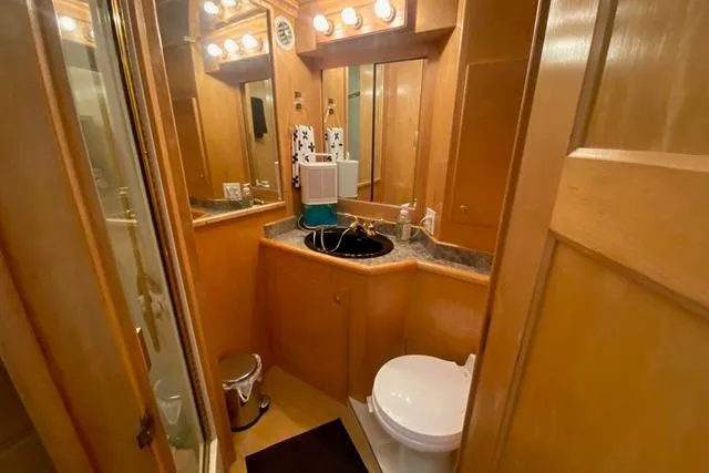 Thistle Do Nicely Yacht Photos Pics Luxurious 1997 Navigator 4200 yacht bathroom with wood paneling and modern fixtures.