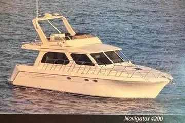 Thistle Do Nicely Yacht Photos Pics 1997 Navigator 4200 yacht cruising on open water, showcasing sleek design and luxury features.