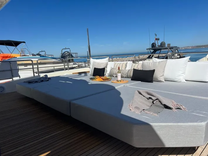 Ganesha Yacht Photos Pics Luxurious Azimut 98 Leonardo yacht deck with sun loungers, cushions, and ocean view.