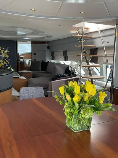 Ganesha Yacht Photos Pics Luxurious interior of 2003 Azimut 98 Leonardo yacht with elegant decor and yellow tulip centerpiece.