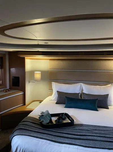 Ganesha Yacht Photos Pics Luxurious bedroom interior of 2003 Azimut 98 Leonardo yacht with elegant decor.