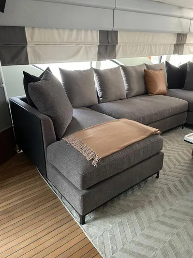 Ganesha Yacht Photos Pics Luxurious interior of 2003 Azimut 98 Leonardo yacht with modern gray sofa.