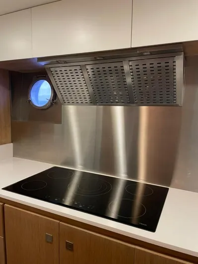 Ganesha Yacht Photos Pics Modern kitchen on 2003 Azimut 98 Leonardo yacht with stovetop and porthole window.