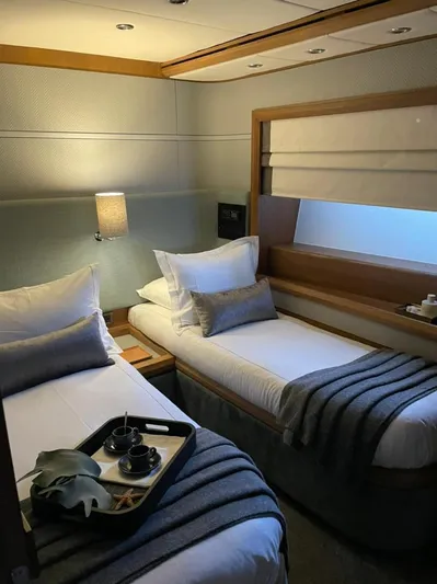 Ganesha Yacht Photos Pics Luxurious cabin interior of 2003 Azimut 98 Leonardo yacht with twin beds and elegant decor.