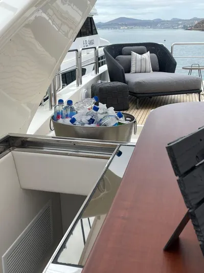 Ganesha Yacht Photos Pics Luxury yacht deck with lounge chairs and ice bucket, Azimut 98 Leonardo, 2003 model.