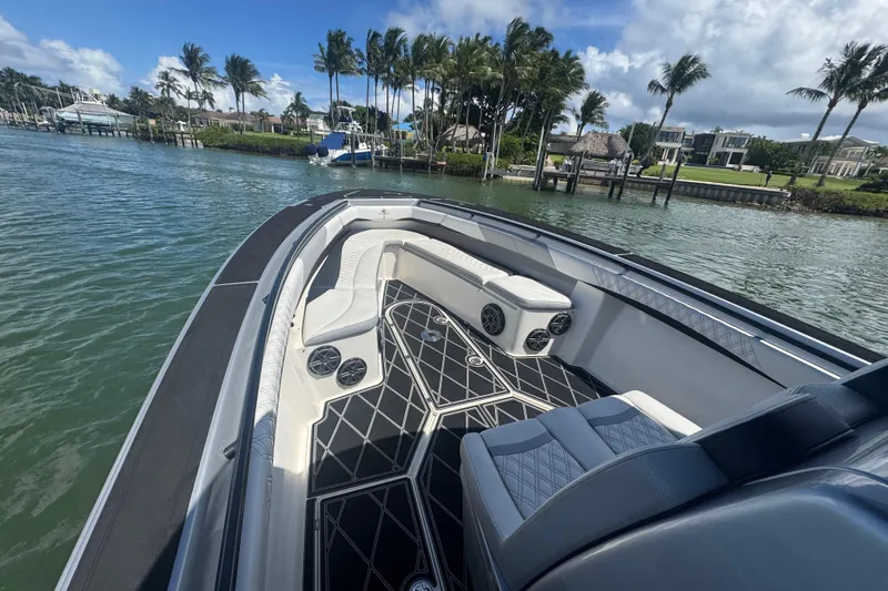  Yacht Photos Pics Luxurious 2016 Statement 380 Open boat with sleek seating, docked near palm trees.