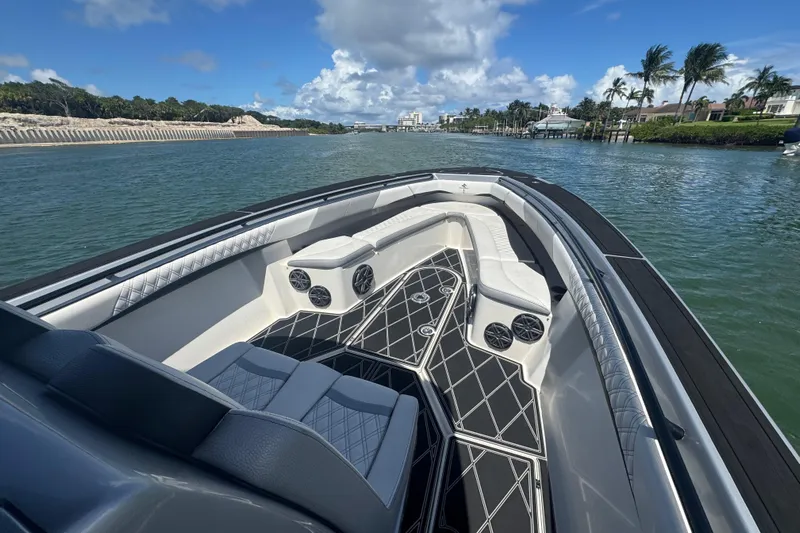  Yacht Photos Pics Luxurious 2016 Statement 380 Open boat interior with elegant seating on a sunny waterway.
