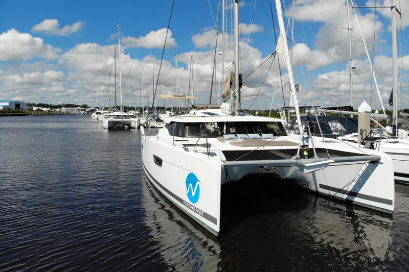 Waymaker Yacht Photos Pics 2018 Fountaine Pajot Saona 47 catamaran docked in a marina under a blue sky.