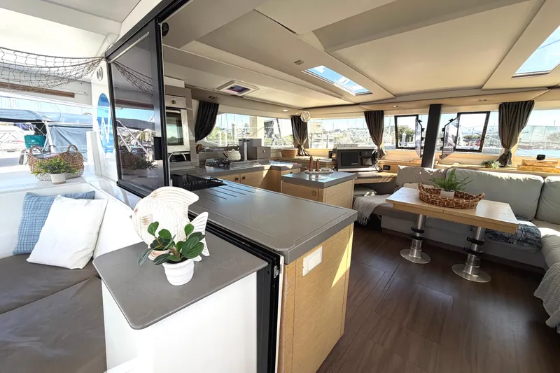 Waymaker Yacht Photos Pics Luxurious interior of 2018 Fountaine Pajot Saona 47 catamaran with modern furnishings and ample natural light.