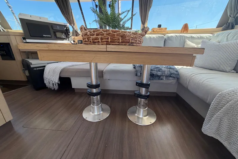 Waymaker Yacht Photos Pics Interior of 2018 Fountaine Pajot Saona 47 catamaran with cozy seating and wooden table.