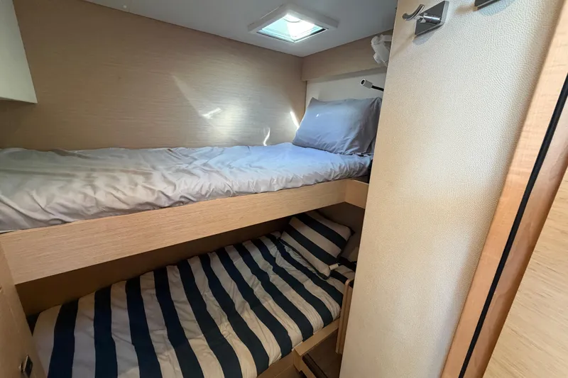 Waymaker Yacht Photos Pics Bunk beds in 2018 Fountaine Pajot Saona 47 catamaran cabin, featuring cozy bedding.