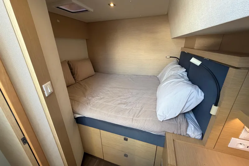 Waymaker Yacht Photos Pics Cozy cabin bedroom in 2018 Fountaine Pajot Saona 47 catamaran, featuring a comfortable bed.