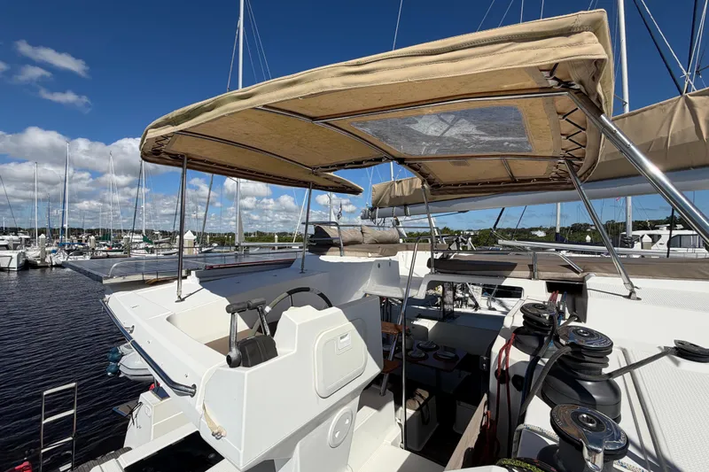 Waymaker Yacht Photos Pics 2018 Fountaine Pajot Saona 47 catamaran cockpit with canopy, docked at marina.