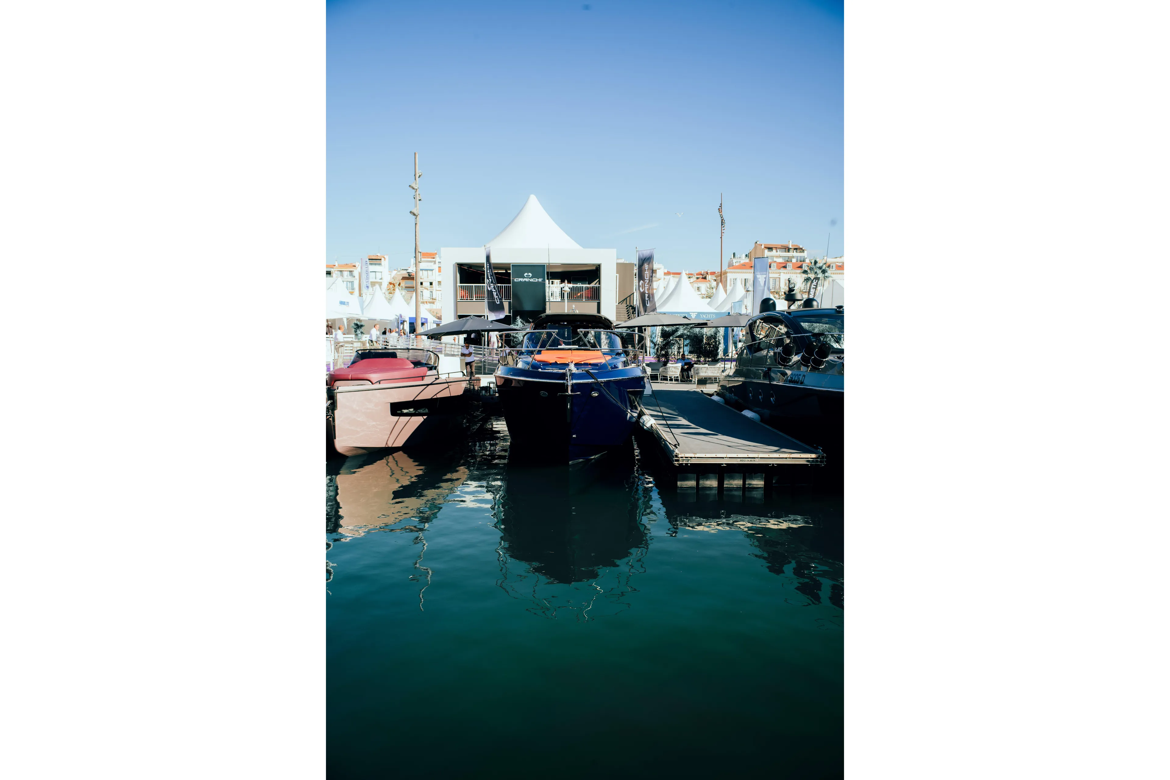  Yacht Photos Pics 2025 Cranchi A46 Luxury Tender docked at marina, surrounded by other boats.