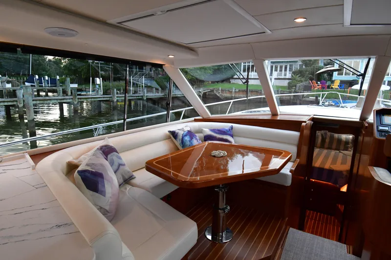 Promesa Yacht Photos Pics Luxurious interior of 2021 Hylas M44 yacht with elegant seating and wooden table.