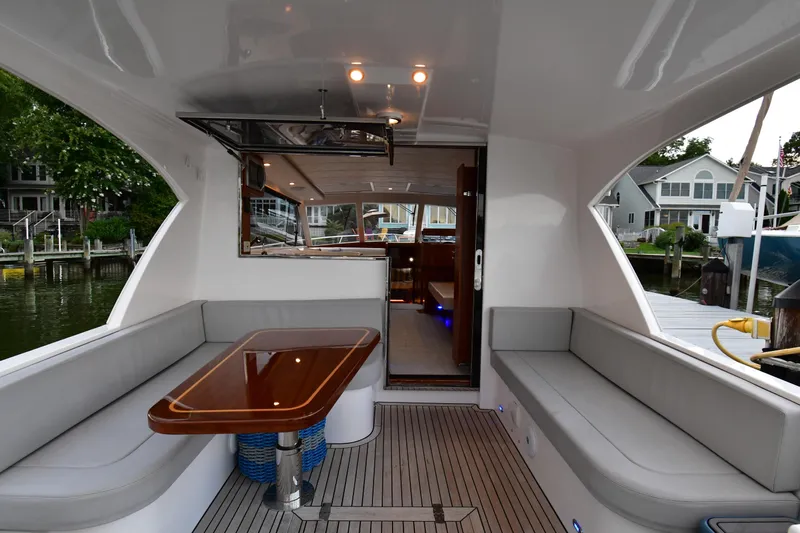 Promesa Yacht Photos Pics Luxurious 2021 Hylas M44 yacht interior with elegant seating and wooden table.