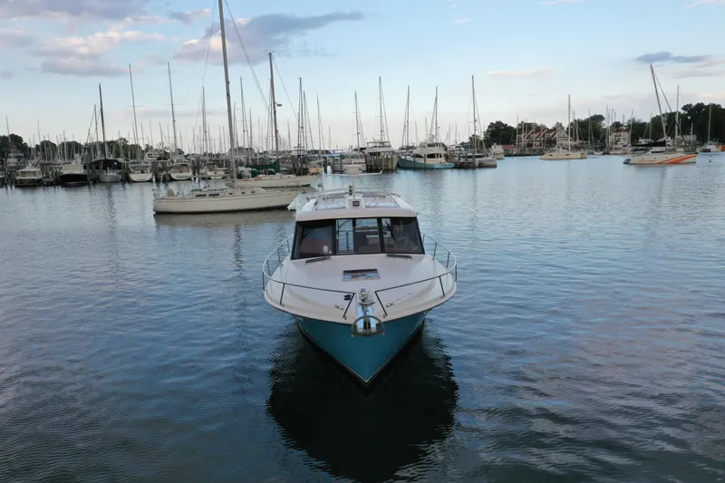 Promesa Yacht Photos Pics 2021 Hylas M44 yacht docked in a marina with sailboats and calm water.