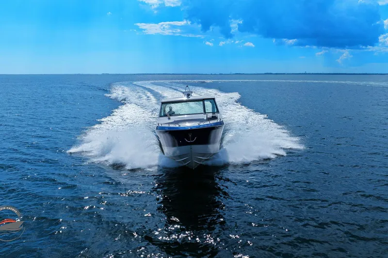 Lucca 2 Yacht Photos Pics 2025 Formula 380 Super Sport Crossover OB cruising on open water under blue sky.