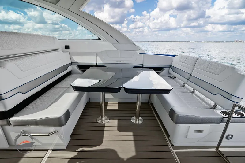 Lucca 2 Yacht Photos Pics 2025 Formula 380 Super Sport Crossover OB interior with sleek seating and table, ocean view.
