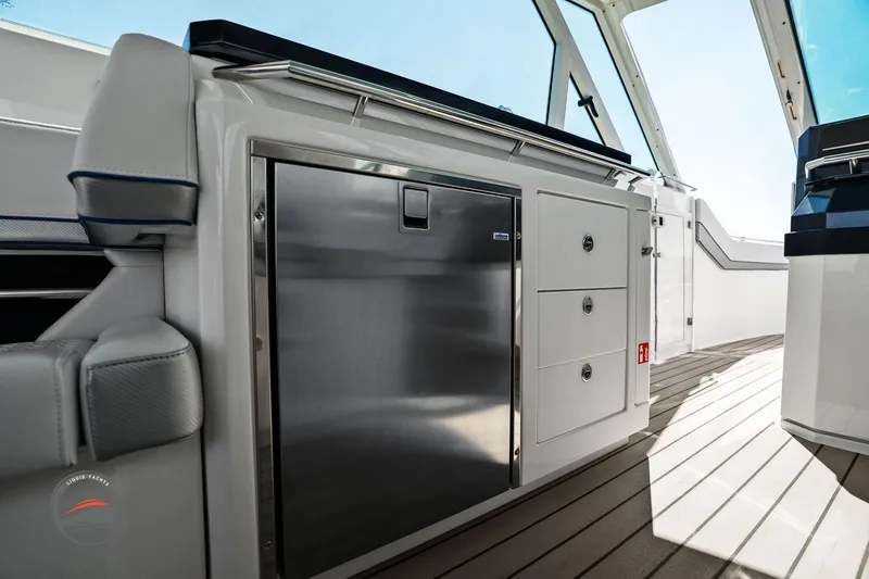 Lucca 2 Yacht Photos Pics 2025 Formula 380 Super Sport Crossover OB interior with sleek cabinetry and stainless steel fridge.