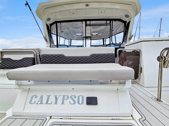Calypso Yacht Photos Pics Aquila 36 Sport 2020 boat with "Calypso" name on the deck, featuring cushioned seating.