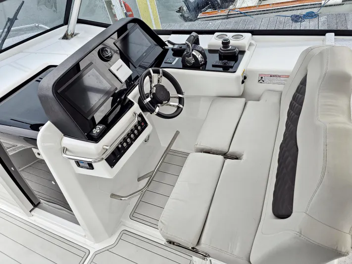 Calypso Yacht Photos Pics Interior cockpit of 2020 Aquila 36 Sport boat with modern controls and seating.