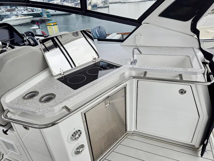 Calypso Yacht Photos Pics Aquila 36 Sport 2020 yacht kitchen with stove, sink, and storage.