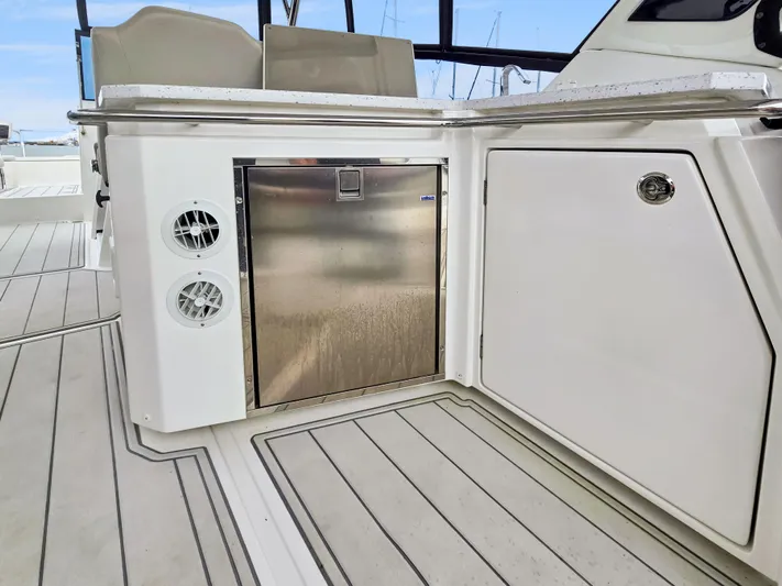 Calypso Yacht Photos Pics Aquila 36 Sport 2020 yacht interior with stainless steel fridge and sleek cabinetry.