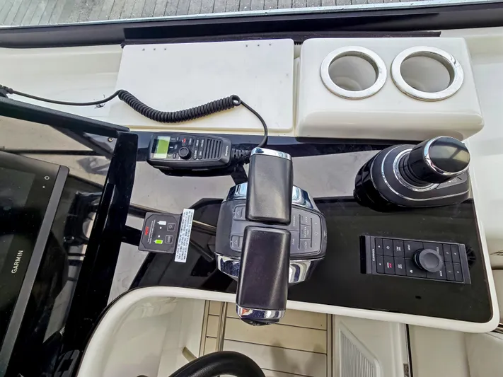 Calypso Yacht Photos Pics Control panel of 2020 Aquila 36 Sport boat with throttle, radio, and cup holders.