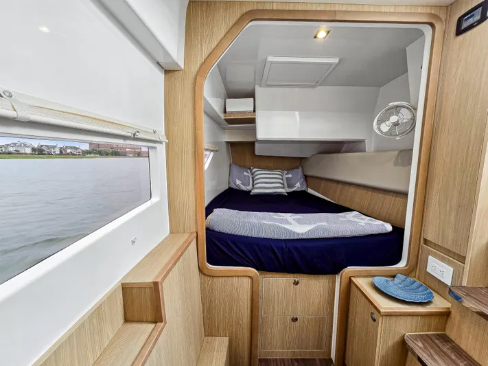 Calypso Yacht Photos Pics Cabin interior of 2020 Aquila 36 Sport yacht with bed and wooden finish.