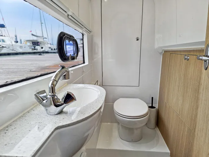 Calypso Yacht Photos Pics Modern bathroom in 2020 Aquila 36 Sport yacht with sleek fixtures and marina view.