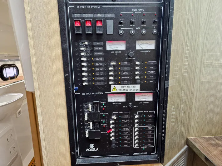 Calypso Yacht Photos Pics Electrical control panel on a 2020 Aquila 36 Sport boat, featuring various switches and indicators.