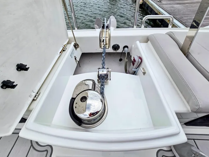 Calypso Yacht Photos Pics Anchor system on 2020 Aquila 36 Sport boat, featuring a polished winch and chain setup.