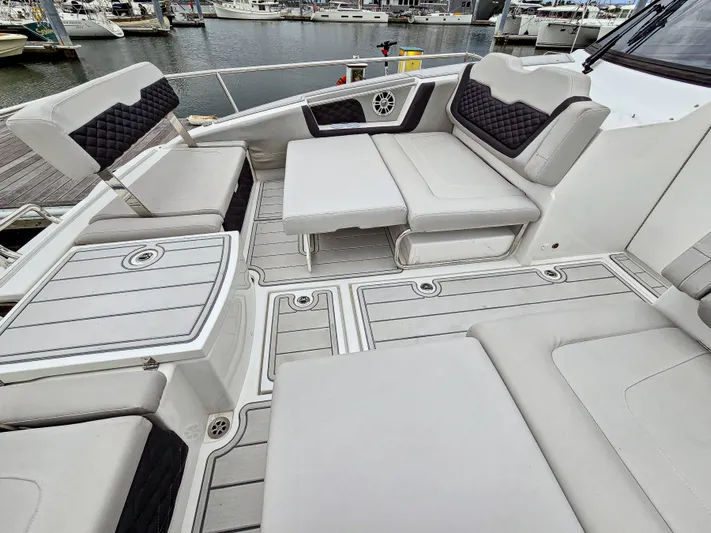 Calypso Yacht Photos Pics Aquila 36 Sport 2020 boat with spacious seating and modern design at a marina.